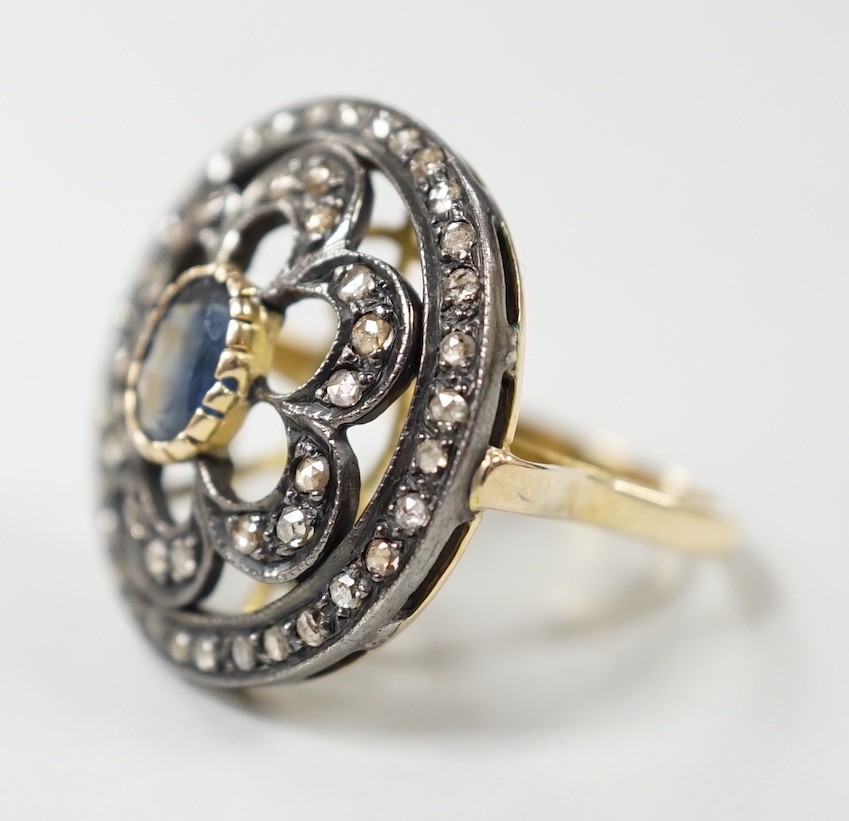 An Indian pierced yellow metal, sapphire and rose cut diamond set circular cluster ring, size N/O, gross weight 8.4 grams.